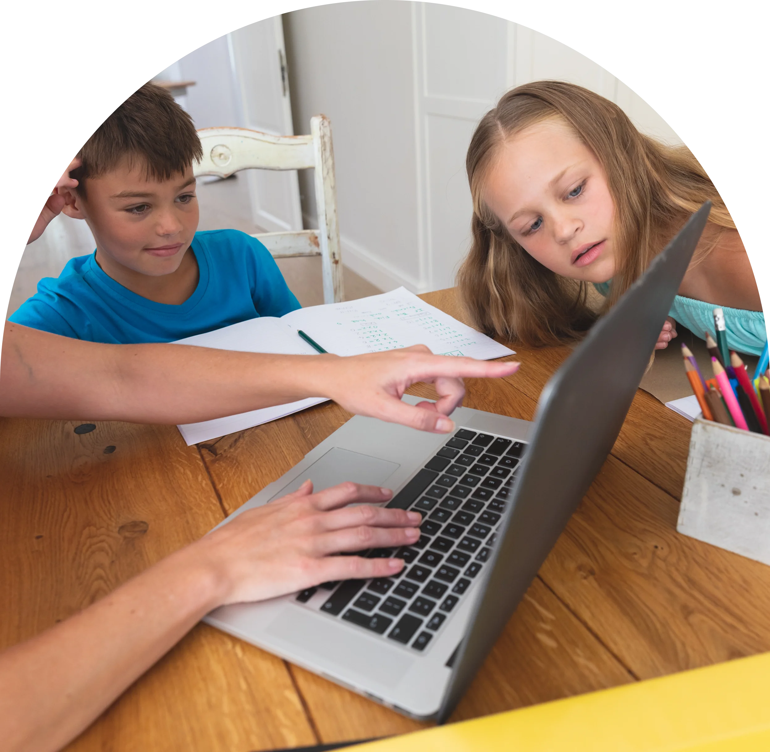 GettyImages-2192762322 (11) Children learning with laptop at wooden table.